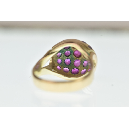 44 - A ruby 14ct yellow gold cluster ring, the domed oval panel inset with rows of circular cut rubies in... 