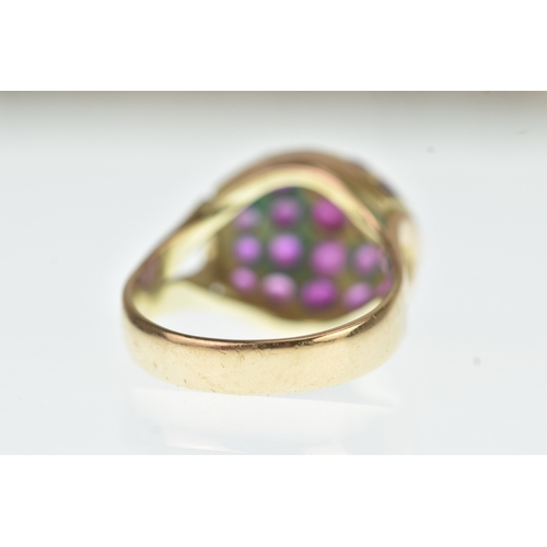 44 - A ruby 14ct yellow gold cluster ring, the domed oval panel inset with rows of circular cut rubies in... 