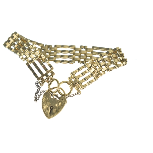 46 - A 9ct gold gatelink bracelet, having a heart padlock clasp and safety chain, stamped 375, 15.8 grams... 