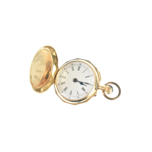 48 - An early 20th century 14ct gold ladies fob watch, having an engine turned case with a vacant shield ... 