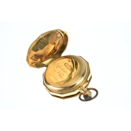48 - An early 20th century 14ct gold ladies fob watch, having an engine turned case with a vacant shield ... 