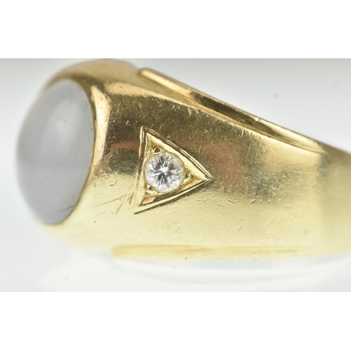 52 - A moonstone and diamond 14ct gold gents ring, the oval moonstone cabochon measuring 10.5mm x 9.5mm, ... 
