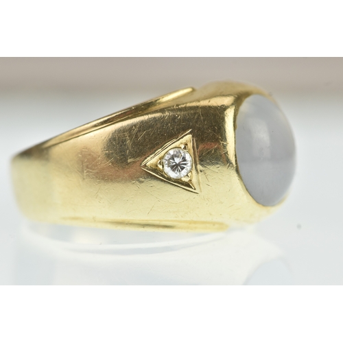 52 - A moonstone and diamond 14ct gold gents ring, the oval moonstone cabochon measuring 10.5mm x 9.5mm, ... 