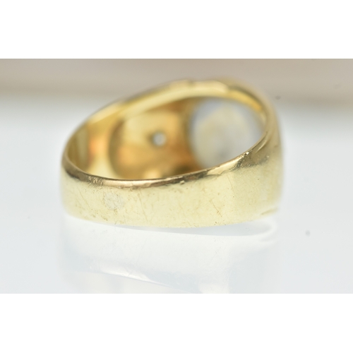 52 - A moonstone and diamond 14ct gold gents ring, the oval moonstone cabochon measuring 10.5mm x 9.5mm, ... 