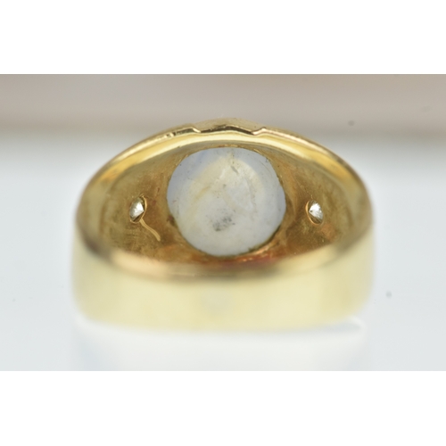 52 - A moonstone and diamond 14ct gold gents ring, the oval moonstone cabochon measuring 10.5mm x 9.5mm, ... 