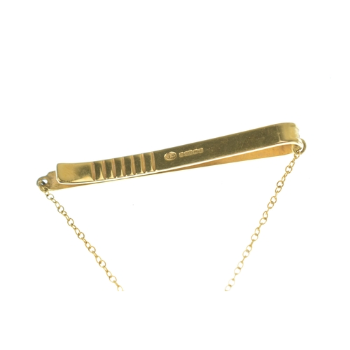 57 - A Shell 40 Year Service tie clip, suspending on chain links a shell inset with four brilliant cut di... 