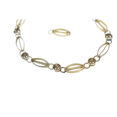 8 - A yellow gold bracelet, featuring marquise-shaped and round links with four leaf clover pierced deco... 