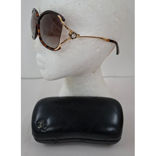 4 - Chanel- A pair of early 1980's over-sized sunglasses with branded black padded case. Location:R1.2
I... 