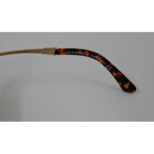 4 - Chanel- A pair of early 1980's over-sized sunglasses with branded black padded case. Location:R1.2
I... 
