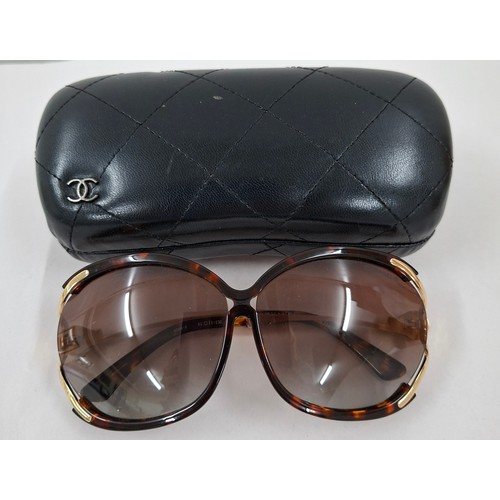 4 - Chanel- A pair of early 1980's over-sized sunglasses with branded black padded case. Location:R1.2
I... 