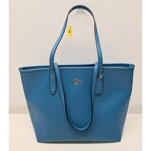 18 - Coach- An Azure blue crossgrain leather and coated canvas 'City Zip' tote bag having silver tone har... 
