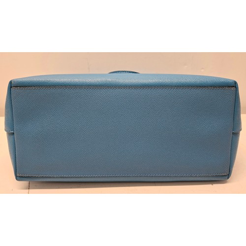 18 - Coach- An Azure blue crossgrain leather and coated canvas 'City Zip' tote bag having silver tone har... 