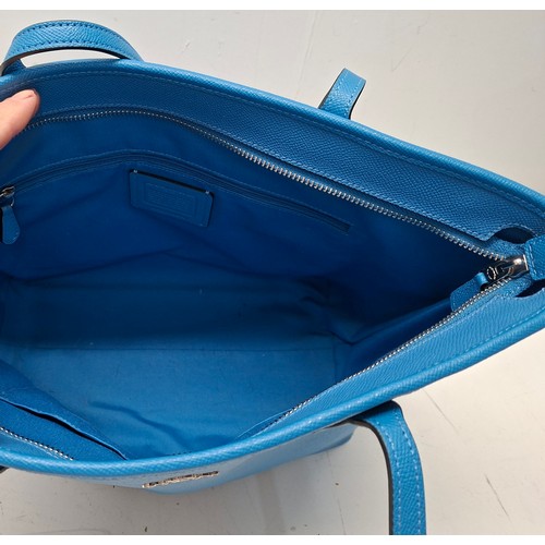 18 - Coach- An Azure blue crossgrain leather and coated canvas 'City Zip' tote bag having silver tone har... 