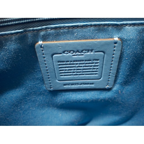 18 - Coach- An Azure blue crossgrain leather and coated canvas 'City Zip' tote bag having silver tone har... 