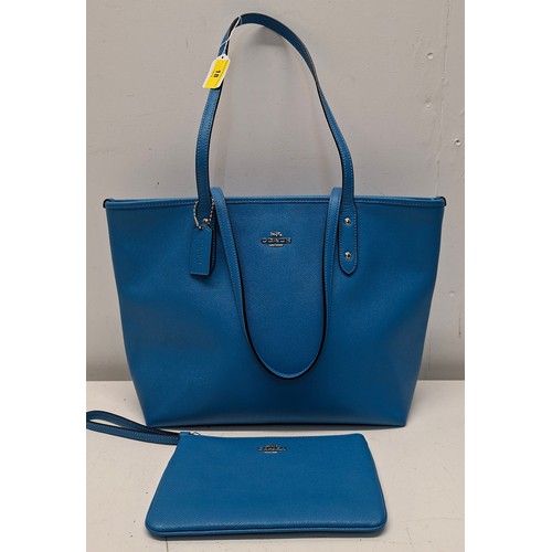 18 - Coach- An Azure blue crossgrain leather and coated canvas 'City Zip' tote bag having silver tone har... 