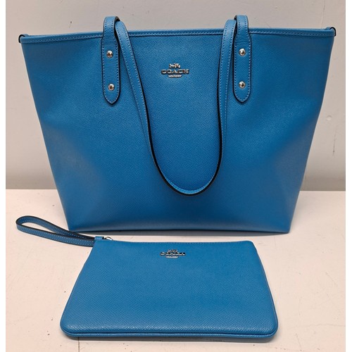 18 - Coach- An Azure blue crossgrain leather and coated canvas 'City Zip' tote bag having silver tone har... 