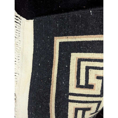 26 - A late 20th century Chinese washed woollen carpet with a dragon on a black ground 180 x 280cm Locati... 
