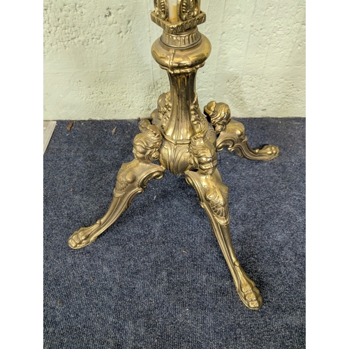 37 - A mid-20th century reproduction coat stand with onyx style column and ornate brass mounts on four sp... 