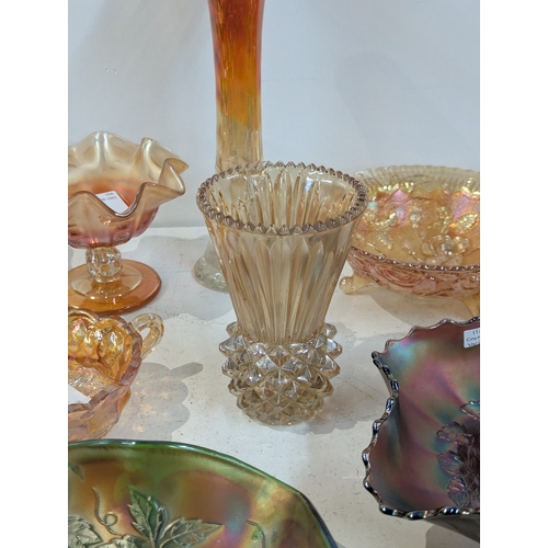 42 - A collection of carnival glass to include a Fenton Dragon and Lotus bowl, Fenton Diamond and Rib vas... 