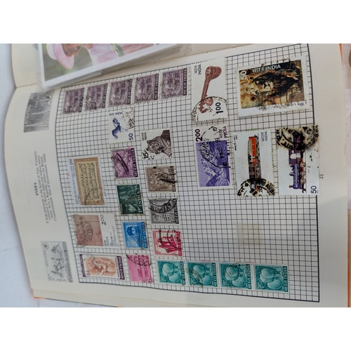 46 - Postage stamps from around the world to include four albums and loose examples from UK, China, India... 