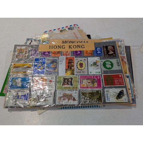 46 - Postage stamps from around the world to include four albums and loose examples from UK, China, India... 