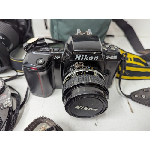 58 - A collection of Nikon cameras and accessories, comprising a Nikon D70 digital SLR camera fitted with... 