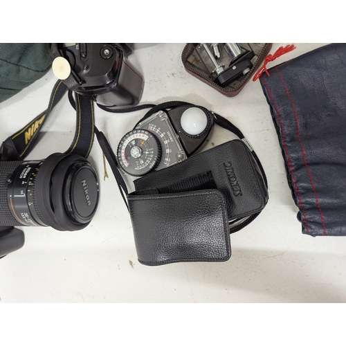 58 - A collection of Nikon cameras and accessories, comprising a Nikon D70 digital SLR camera fitted with... 