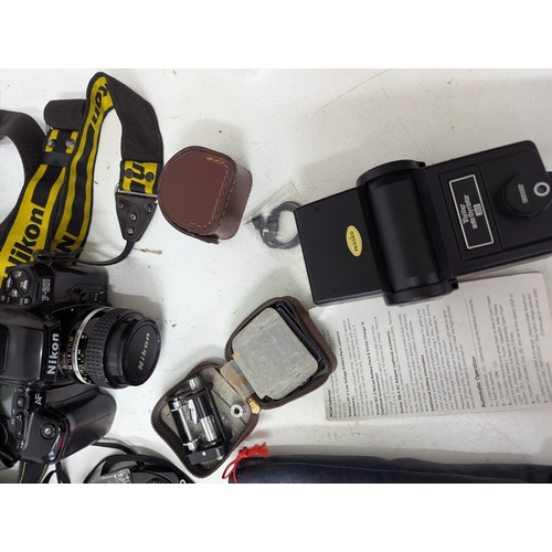 58 - A collection of Nikon cameras and accessories, comprising a Nikon D70 digital SLR camera fitted with... 