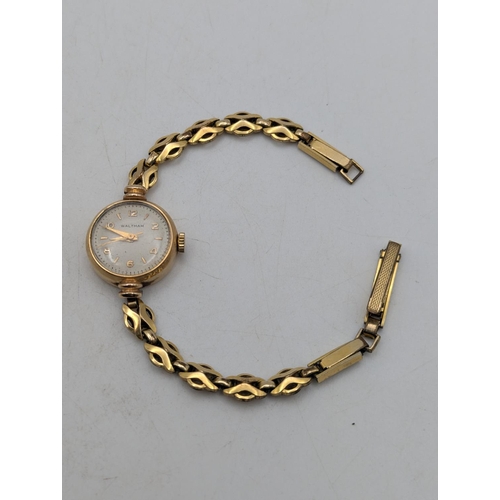 14 - A 9ct yellow gold  cased ladies Waltham wristwatch on a gold-plated bracelet, total weight 15.6g
Loc... 