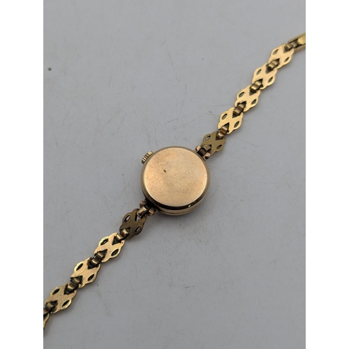 14 - A 9ct yellow gold  cased ladies Waltham wristwatch on a gold-plated bracelet, total weight 15.6g
Loc... 