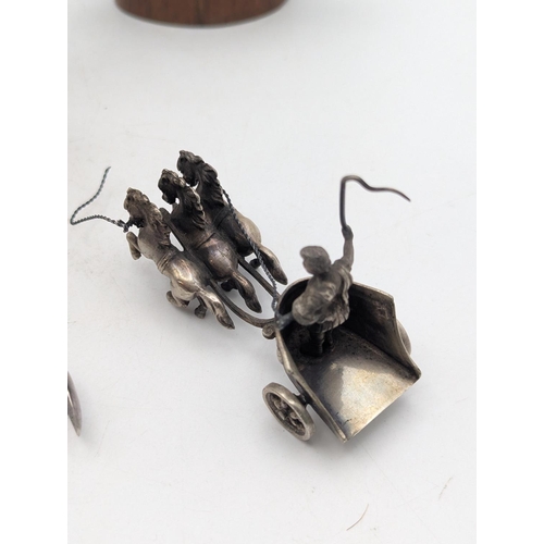 17 - Silver and white metal items to include a small pair of sugar tongs 13.2g together with two white me... 