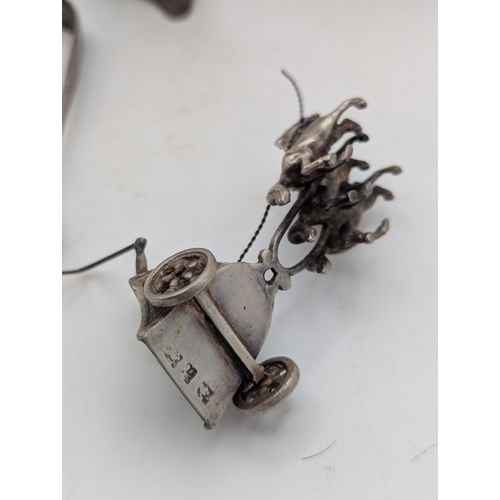 17 - Silver and white metal items to include a small pair of sugar tongs 13.2g together with two white me... 