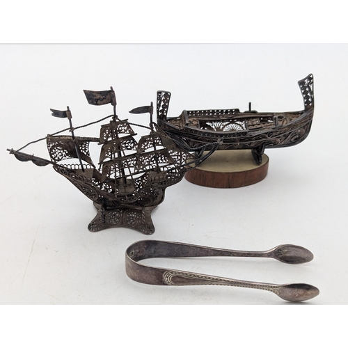 17 - Silver and white metal items to include a small pair of sugar tongs 13.2g together with two white me... 