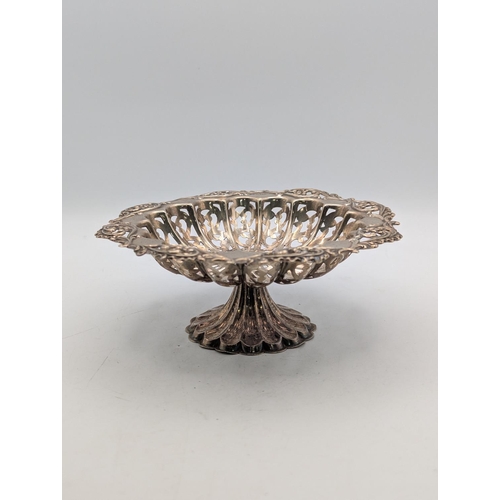 20 - An Edwardian silver pedestal dish, having pierced design, embossed floral border, reeded tapering ba... 