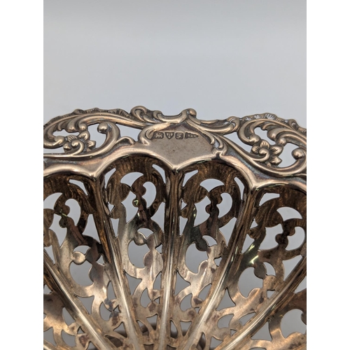 20 - An Edwardian silver pedestal dish, having pierced design, embossed floral border, reeded tapering ba... 