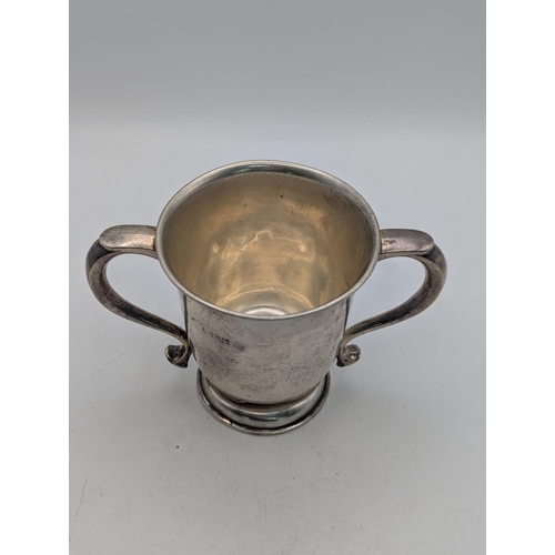 22 - A George V silver trophy cup with twin handles, circular foot, hallmarked Birmingham 1921, 103.2g
Lo... 