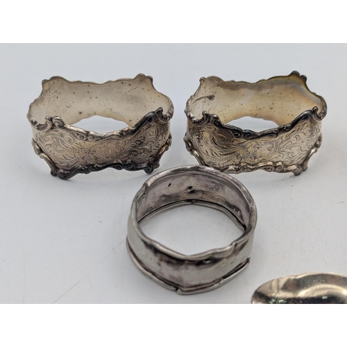 27 - Mixed silver to include four assorted napkin rings along with two spoons, total weight 87.2g and a s... 