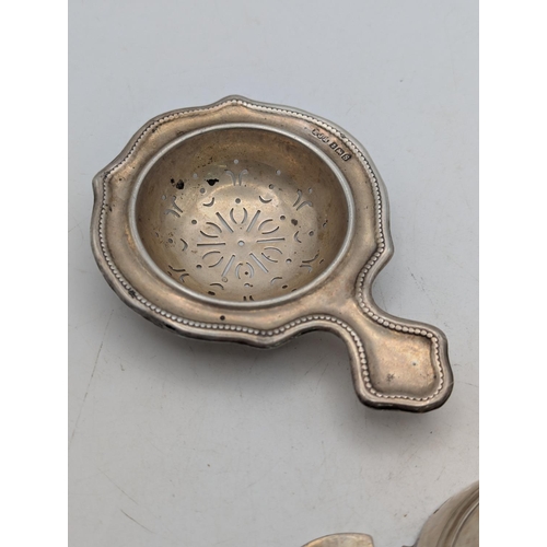 36 - A silver tea strainer hallmarked Birmingham 1942 by E J Evans and Co, along with a quaich in set wit... 