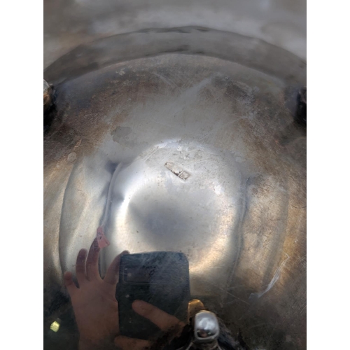 43 - An Egyptian silver dish with repeating bow shaped pierced border, 20cm diameter, on three feet, 248.... 