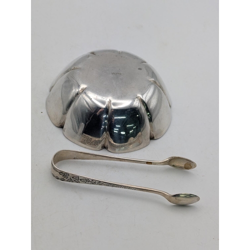 44 - A silver coloured dish with ribbed design, stamped silver to the base, together with a pair of flora... 