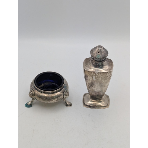 47 - Silver pepper pot with a tapering body together with a silver slat with blue glass liner, total weig... 
