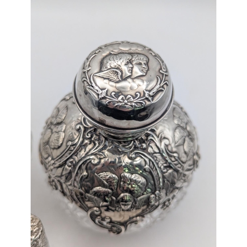 48 - Two late 19th/early 20th century silver and cut-glass dressing table scent bottles, one mounted with... 