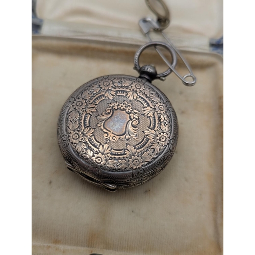 59 - A white metal dish having repeating pierced decoration, together with two silver topped dressing tab... 
