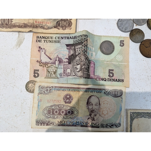 12 - World coinage and banknotes to include France, Britain and others, Malaya 5-cents banknotes and othe... 