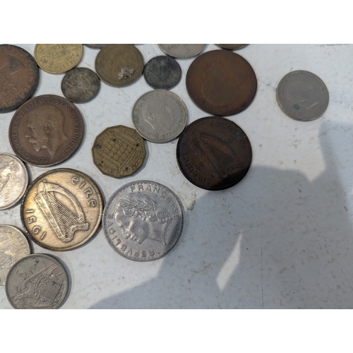 12 - World coinage and banknotes to include France, Britain and others, Malaya 5-cents banknotes and othe... 
