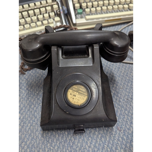 14 - A mixed lot to include two Bakelite telephones, Olympia typewriters, a pair of binoculars and other ... 