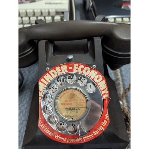 14 - A mixed lot to include two Bakelite telephones, Olympia typewriters, a pair of binoculars and other ... 