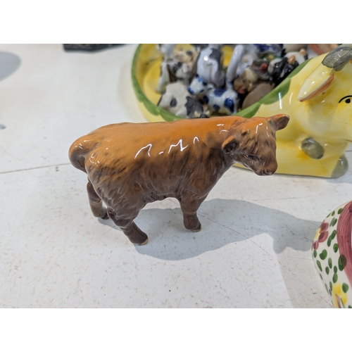 15 - A mixed lot of ceramics to include an assortment of bovine related ceramics to include a Beswick tog... 