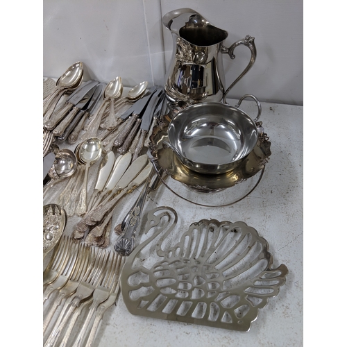 33 - Silver plated and E.P.N.S. items to include assorted flatware and cutlery, a large tray stand fashio... 