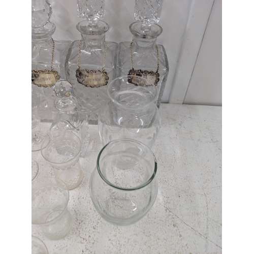 37 - A collection of glassware along with four crystal decanters all with decanter labels, one silver hal... 